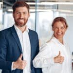 Office employees group showing thumbs up looking at camera, happy professional multicultural team.